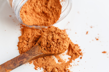 Goji Berries powder on wooden spoon