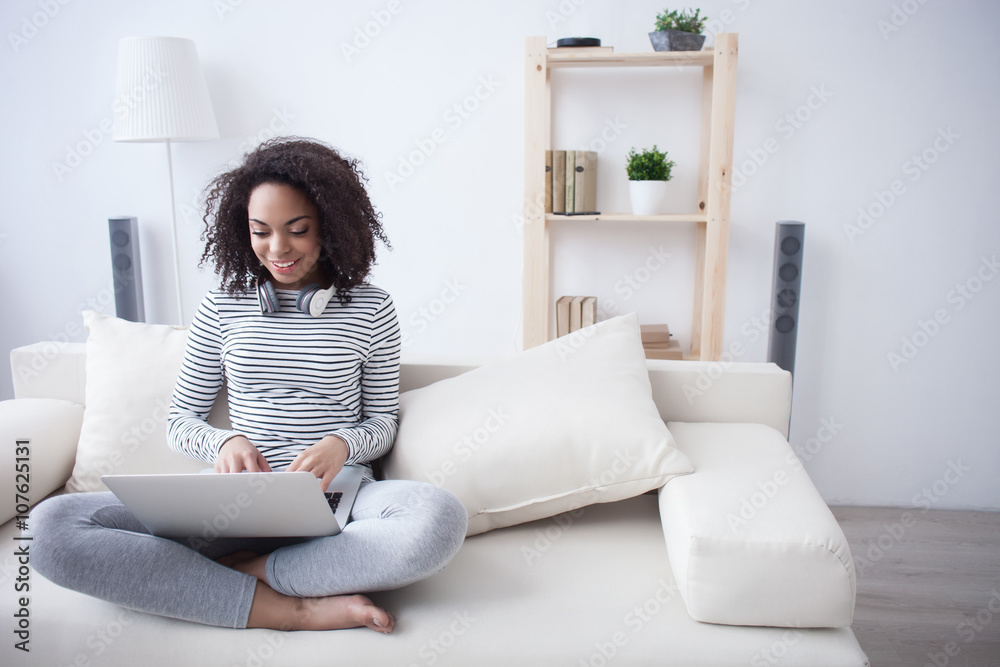 Wall mural Attractive girl is using a notebook