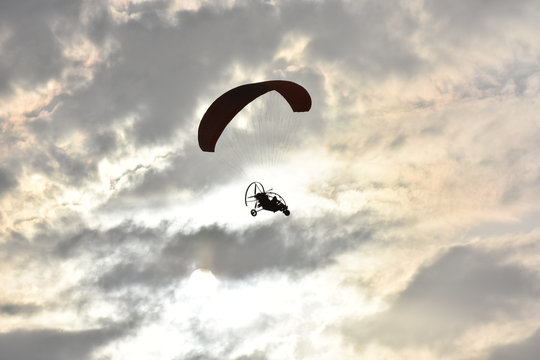 Paragliding on sunset,  silhouette of para-motor glider