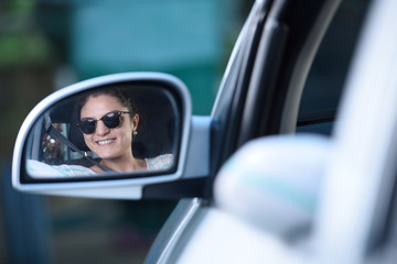 Girl driving reflection on mirror