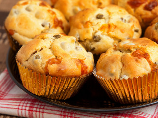 Savory muffins with ham, cheese dried tomatoes. Horizontal shot, close up