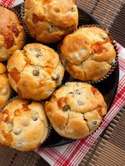 Savory muffins with ham, cheese dried tomatoes, shot from above