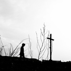 silhouette of man near the cross