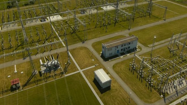 Aerial perspective of power substation on sunny summer day.
