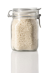 Basmati rice in a jar with reflection on white.
