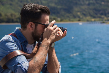 A young photographer at a lake of the Patagonia Argentina .