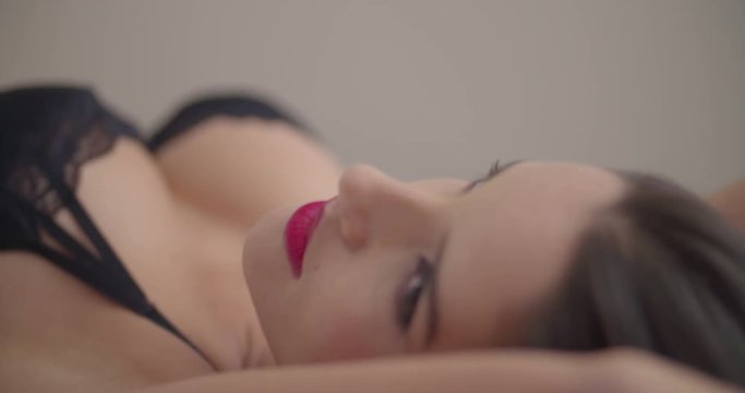 Sexy elegant lady in seductive underwear on bed