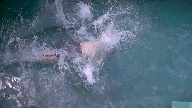 Man falling into a swimming pool and floating dead
