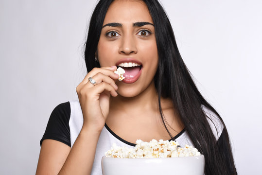 Young Woman Eating Popcorn