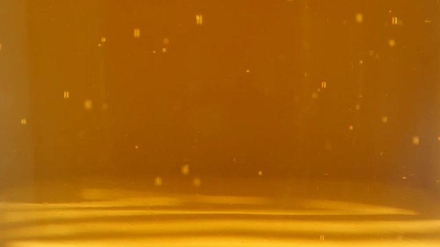 View on golden beer in the glass spreading bubbles 4K 2160p 30fps UltraHD footage - Light beer foam in bubbles slow spreading in glass 4K 3840X2160 UHD video 