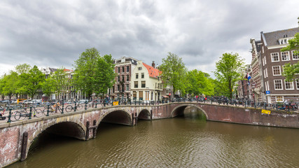 Fototapeta premium Bicycles lining a bridge over the canals of Amsterdam, Netherlands. 