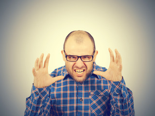 Naklejka premium Angry bald man in glasses.