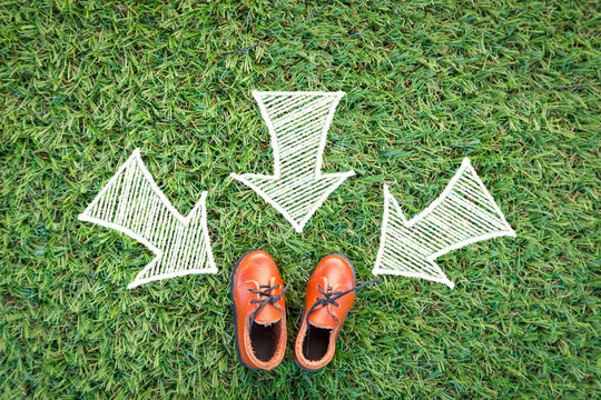 shoe with white drawing arrow  on grass floor.jpg