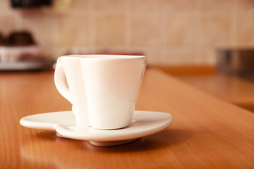Empty tea coffee cup mug on saucer. Heart shape.