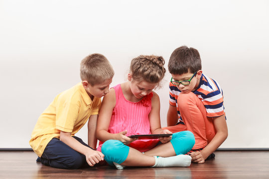 Kids Playing On Tablet.
