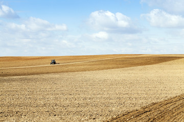 tractor plowing the fields  