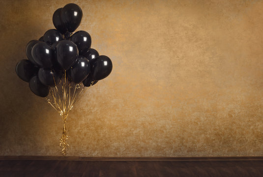 Bunch Of Black Balloons On Gold Background