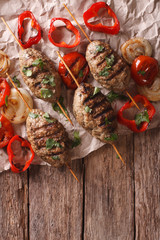 Turkish kebab with grilled vegetables on the table. vertical top view
