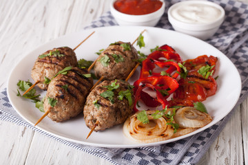 Tasty kofta kebab with grilled vegetables on a plate. horizontal
