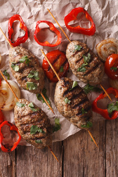 Turkish kebab with grilled vegetables close-up on the table. vertical top view
