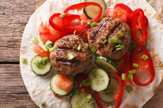 Meatballs with fresh vegetables and Flatbread close-up. Horizontal top view
