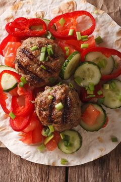 Meatballs with fresh vegetables and Flatbread close-up. vertical top view
