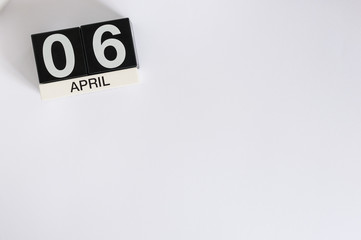 April 6th. Image of april 6 wooden color calendar on white background.  Spring day, empty space for text