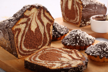Swirl cake with chocolate on wooden board