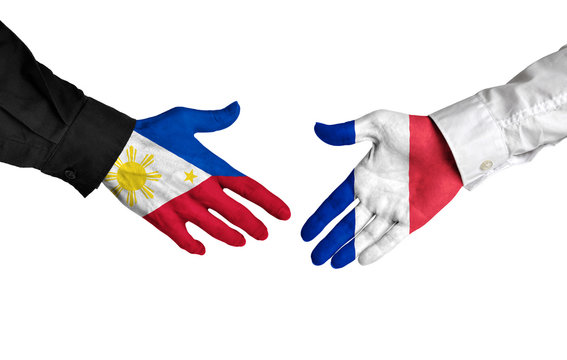 Philippines and France leaders shaking hands on a deal agreement