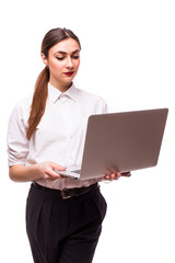 Happy young woman holding laptop and looking at camera over white background