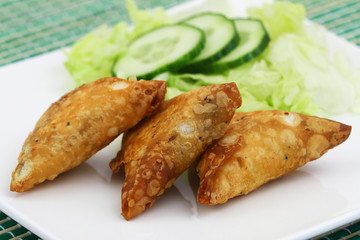 Indian samosas with green side salad, closeup
