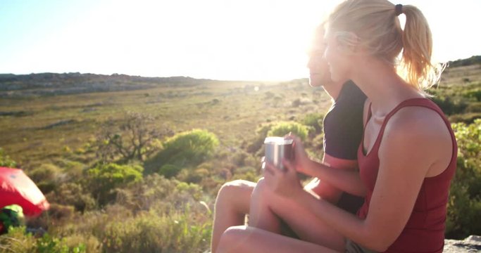 Camping Hiker drinking coffee in nature next to tent