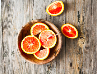 Sicilian red oranges slices in a wooden plate, healthy snack