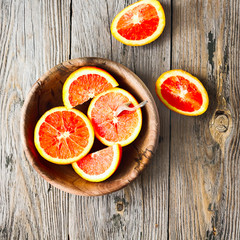Sicilian red oranges slices in a wooden plate, healthy snack