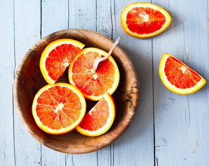 Sicilian red oranges slices in a wooden plate, healthy snack