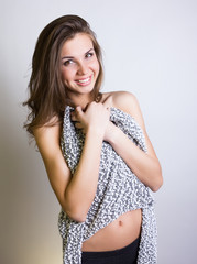 sexy slim girl in short knitted cardigan and leggings posing. she took off her cardigan and shyly...