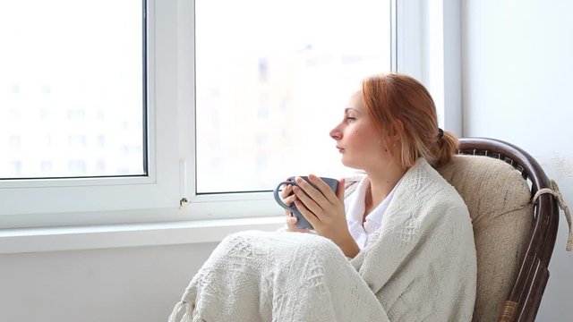 Gorgeous dark haired young woman sitting drinking coffee 