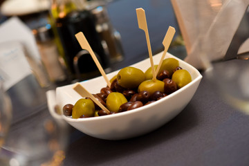 Olive green and black in a white ceramic bowl