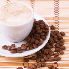 Cup of coffee, sweets and cane sugar cubes, square. Coffee concept. Selective focus.