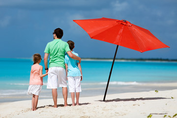 Father with kids at beach