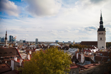 Naklejka premium View on historic centre of Tallinn in the Estonia. Red roofs of the old houses of the European city Tallinn. The ancient architecture. Roof with wings.