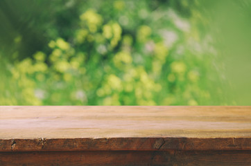front rustic wood boards and abstract forest background. vintage filtered and toned
