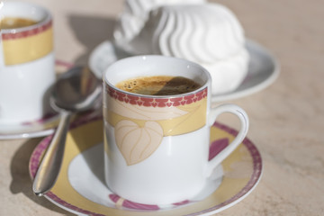 Coffee cup saucer and spoon.
