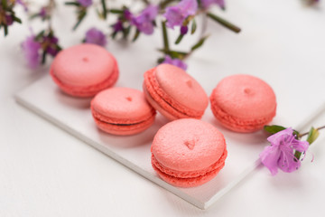 Bright macaroons on the wooden background. Shallow depth of field.