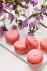 Bright macaroons on the wooden background. Shallow depth of field.