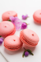 Bright macaroons on the wooden background. Shallow depth of field.