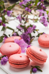 Bright macaroons on the wooden background. Shallow depth of field.