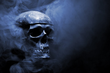 front of real skull in abstract smoke
