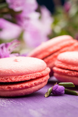Bright macaroons on the wooden background. Shallow depth of field.