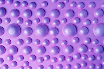 Orthopedic bubble mat for children massage. Purple background